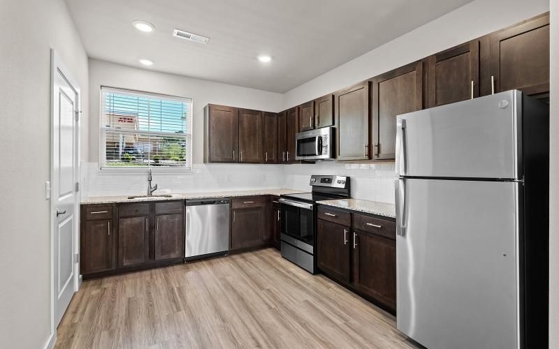 a kitchen with wooden cabinets